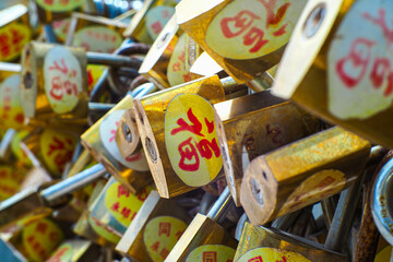 Chinese garden padlocks written with well-wishes using a master key lock on a steel chain
