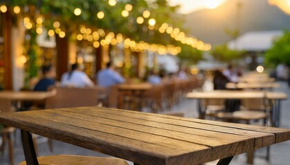 Empty brown wooden tables and bokeh lights blur. The abstract background of a cafe