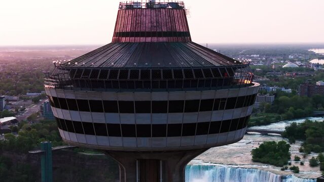 Aerial Panning Scenic View Of Skylon Observation Deck Over Niagara River At Sunset - Niagara Falls, Canada