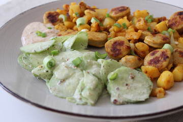 Delicious German Sausage and Potato Skillet with Refreshing Cucumber Salad