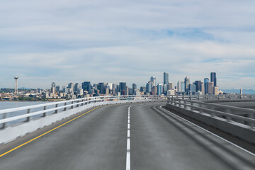 Empty urban asphalt road exterior with city buildings background. New modern highway concrete construction. Concept way to success. Transportation logistic industry fast delivery. Seattle. USA.