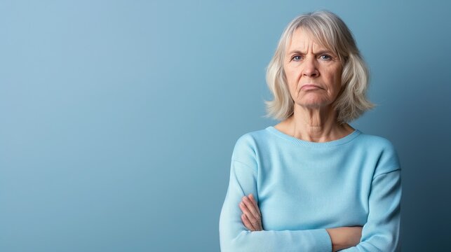 Senior White Woman Unhappy with Light Blue Background Space