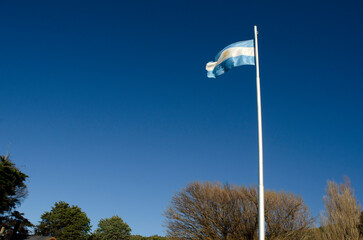 flag of the Argentine Republic flying over the blue sky