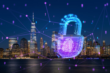Manhattan skyline at night with a futuristic hologram of a padlock and fingerprint over cityscape....