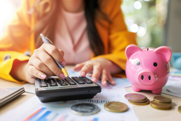 Women calculate expenses with calculator and piggy bank. Tax time, finance, investment and savings concept - 766409565