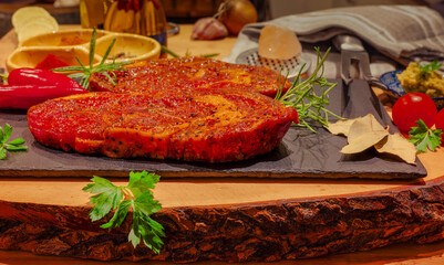 Marinated raw entrecote steak with fresh ingredients. 