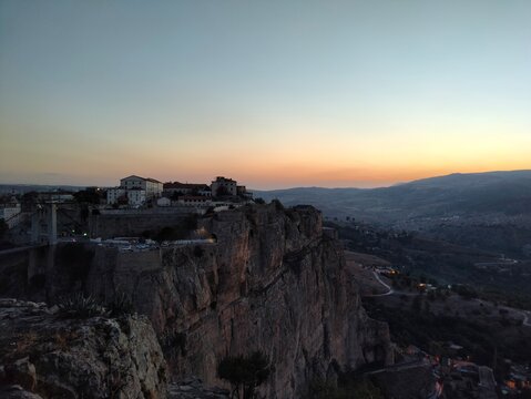 A city built on the top of rock and its suspension bridge at sunset in Constantine, Algeria