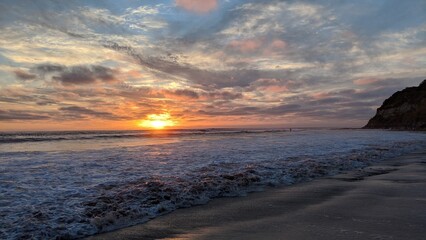 Southern California beach scenes with sunsets, surfers, tide pools and palms trees at Swamis Reef...