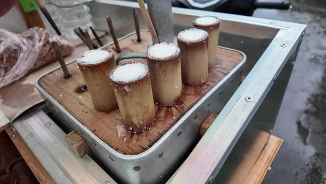 4k slow motion video footage - Cooking process of Kue Putu using cylindrical bamboo mold and steamer. Indonesian traditional food or snack from Java, made from grated coconut, brown sugar, palm sugar.