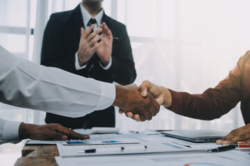 Real estate agent and customers shaking hands together celebrating finished contract after about home insurance and investment loan, handshake and successful deal. - obrazy, fototapety, plakaty