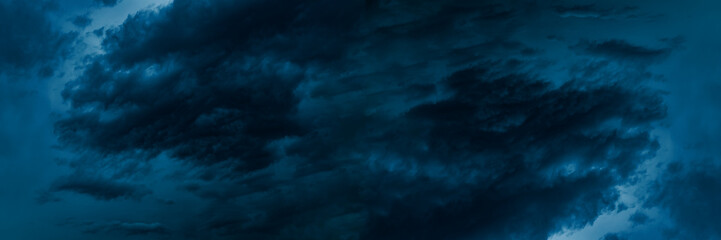 Dark blue cloudy sky before thunderstorm. Storm gloomy heaven cloudscape. Nature dramatic skyscape...