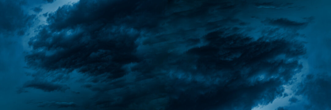 Dark blue cloudy sky before thunderstorm. Storm gloomy heaven cloudscape. Nature dramatic skyscape wide banner background