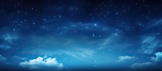 The night sky is filled with a multitude of stars shining bright amongst fluffy white clouds, creating a beautiful natural landscape against the electric blue atmosphere