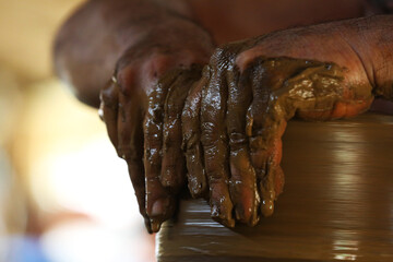 Potter's hands from the town of Quezaltepeque , El Salvador create clay figures - obrazy, fototapety, plakaty