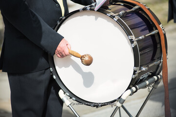 Details of hands playing the bass drum