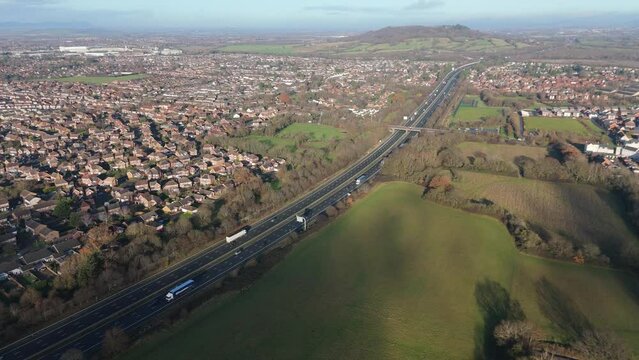 Static Serenity: Aerial View of M5 Highway Bridge Over River by Residential Greens