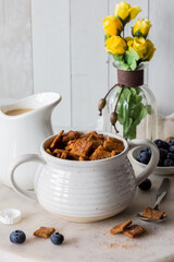 A bowl of homemade low carb cinnamon crunchy cereal served with oat milk.
