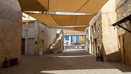 Street of Dubai old city Al Seef Khor in Al Fahidi neighborhood, United Arab Emirates. Waterfront...