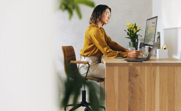 Focused businesswoman implementing digital marketing strategy in office
