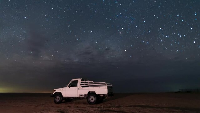 Time lapse of night Stars milky way motion across night sky during off road camping in desert
