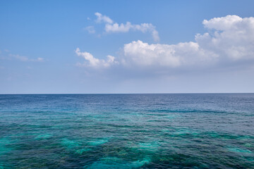 Blue ocean horizon blue sky and clouds