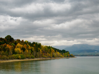 Autumn Mountain Landscape. Dramatic sky. In the foreground Liptovska Mara and autumn's trees. Zilina Region. Vlachy. Slovakia