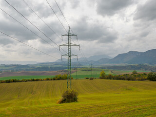 Landscape with dramatic sky. View of the Hoczańskie Mountains. In the foreground, a farmland and...