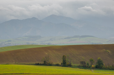 Mountain landscape. In the foreground, a farmland . In the distance you can see the Low Tatras Zilina Region. Liptovske Matiasovce. Slovakia.