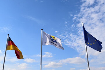 flags of Germany, the EU and village Wellen