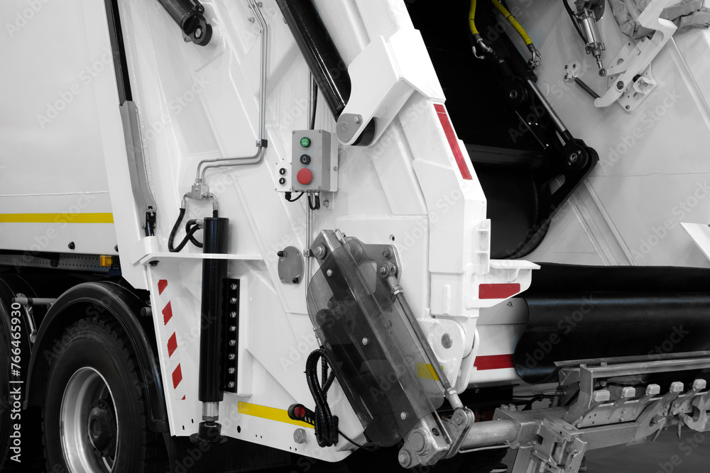 Poster A modern machine for transporting waste waste with a press and automatic loading and unloading, rear view of the mechanization and trash can