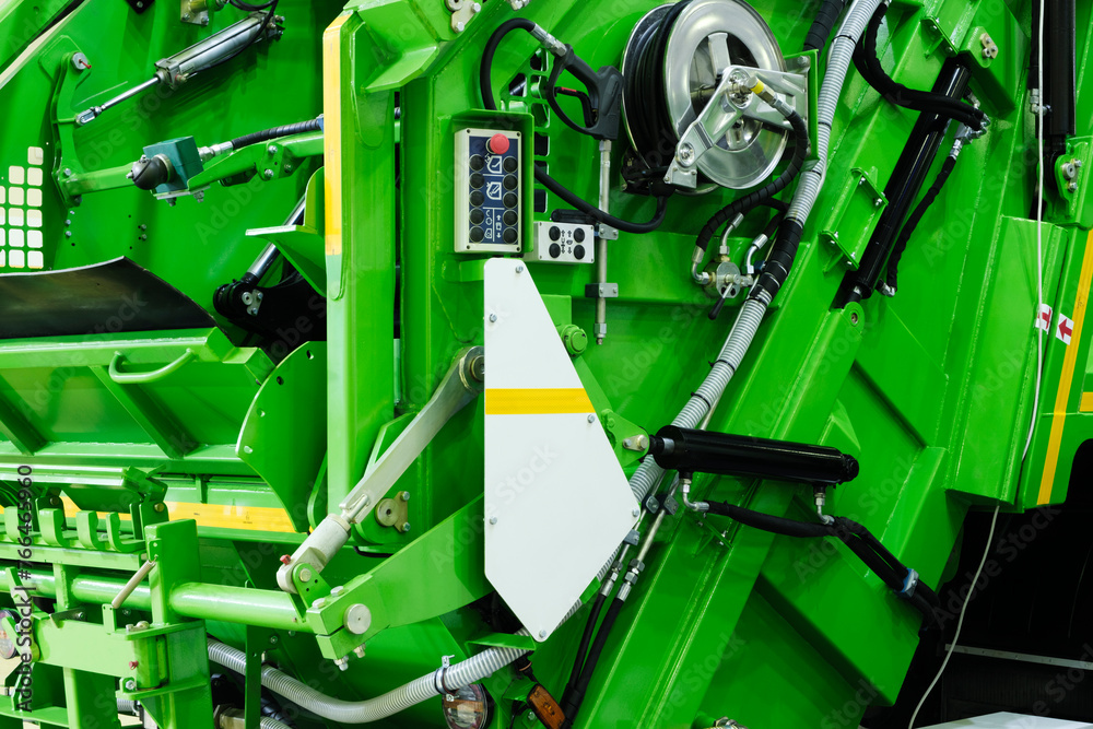 Poster A modern machine for transporting waste waste with a press and automatic loading and unloading, rear view of the mechanization and trash can