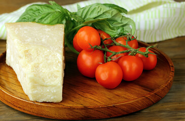parmesan cheese with fresh basil on wooden background