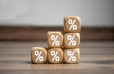 Cubes, dice or blocks with percent sign symbols on wooden background