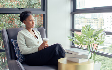 Portrait African smart business female entrepreneur, manager wearing formal green suit, smiling...
