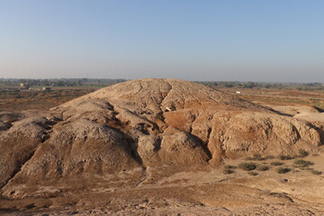 Ancient city of kish , 3100 bc , al-ahmar hill in Babylon in Iraq , ancient ruins with blue sky 