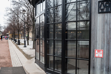 Stylish glass facade with black frames on the windows in the cold season in new holland. 