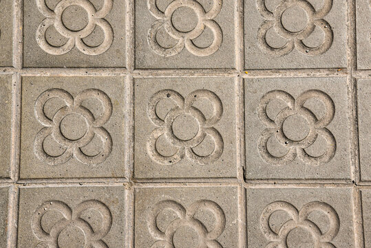 typical flower tiles by the sidewalks in Barcelona