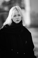 Portrait of a young beautiful blonde girl in black and white style.