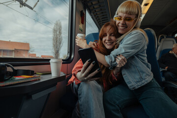 Friends sharing a hug on a train - 766481388
