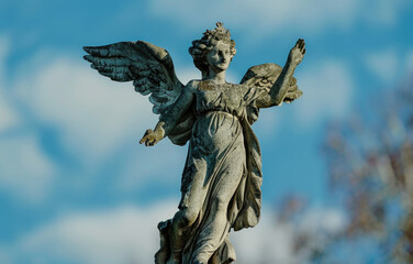 Fototapeta premium Angel statue on top of a building, suitable for architectural projects