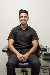 Fototapeta premium Portrait of a young man sitting in a barber chair