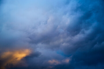 Fototapeta na wymiar Glow through dark clouds, light among clouds