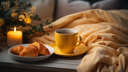 A cozy still life of a cup of coffee, croissants, and a candle - obrazy, fototapety, plakaty