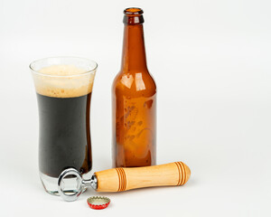 Poured Bottle of beer with bottle opener and glass