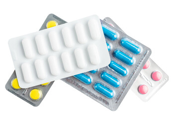Various medicine capsules, pills and tablets in a blister pack isolated on transparent background,...
