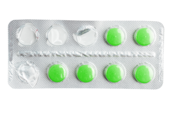 Green medicine pills in a blister pack isolated on transparent background, healthcare and medicine concept, top view