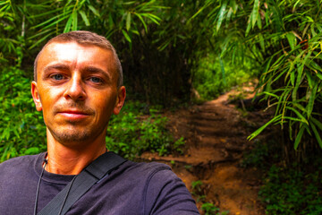 Naklejka na ściany i meble Man tourist Tropical jungle forest hiking trails Chiang Mai Thailand.