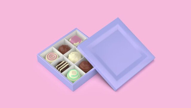 Gift box with a selection of chocolate pralines on pink background