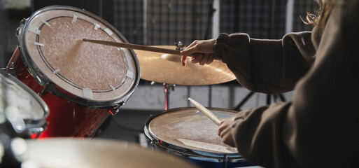 Drummers Hands Holding Sticks Mid-Performance on a Drum Set - 766505193