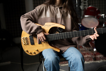 Young Musician Playing electric Guitar in a Studio Setting During a Rehearsal, playing accord - 766506559